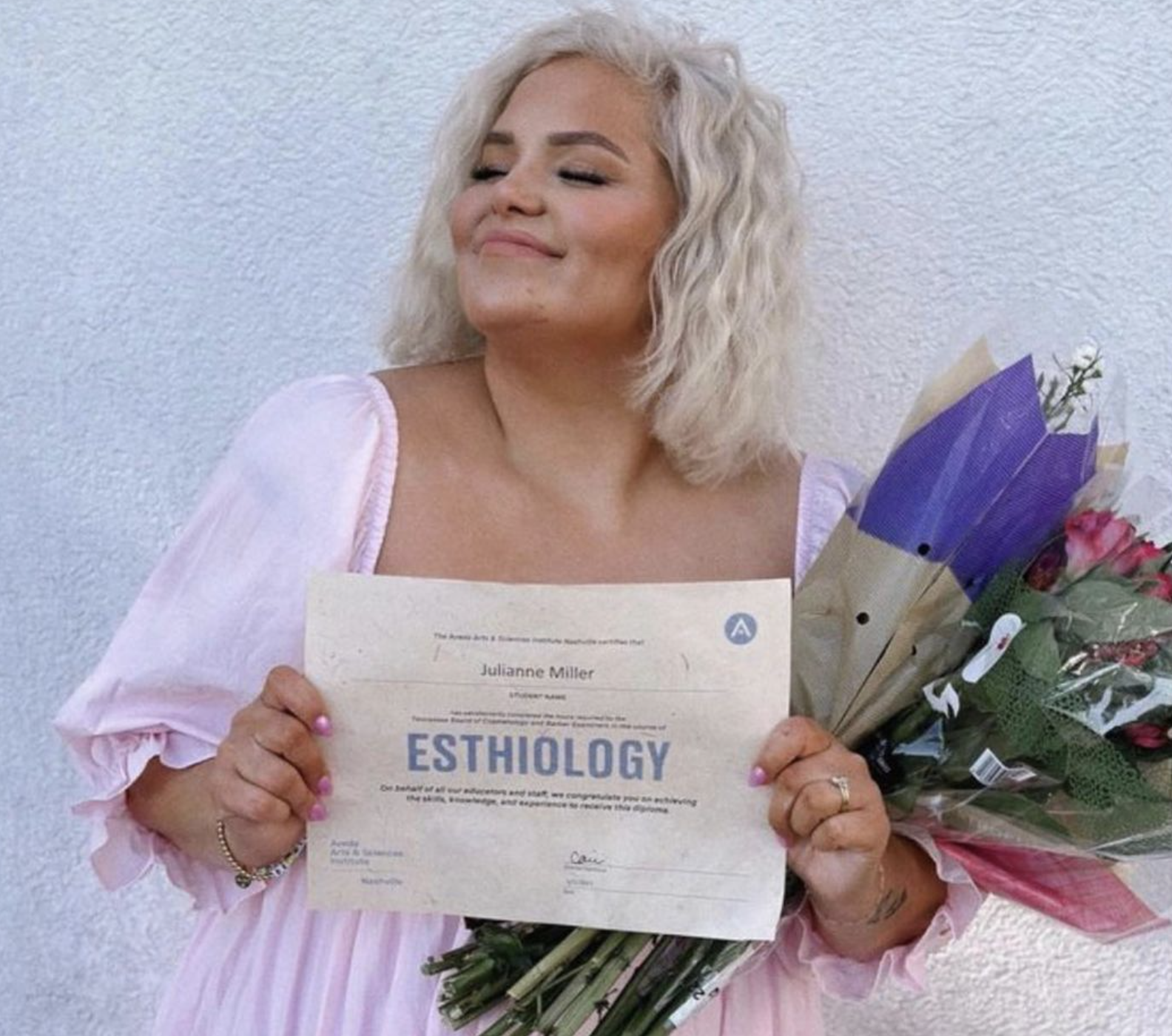 Aveda Arts & Sciences Institute Esthetics Graduate Holding Certificate and Flowers