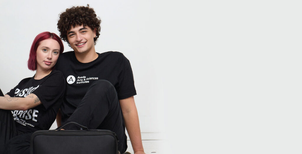 No Saturday Schedule. New Flexible Schedule at Aveda Arts Select Campuses - Two Happy Students in Aveda Arts Gear