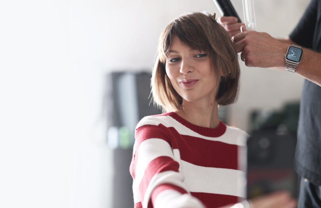 Gen Z Hair Model Taking Selfie with iPhone