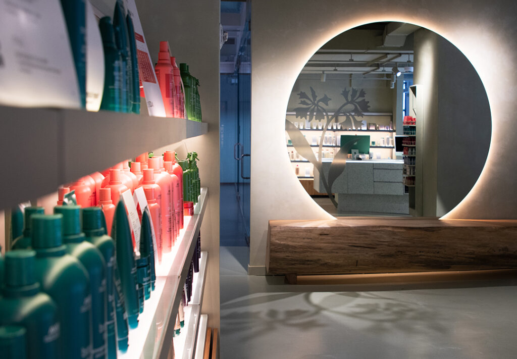 Modern Aveda retail area inside Aveda Arts & Sciences Institute New York in DUMBO Brooklyn featuring professional haircare, skincare, and beauty products.