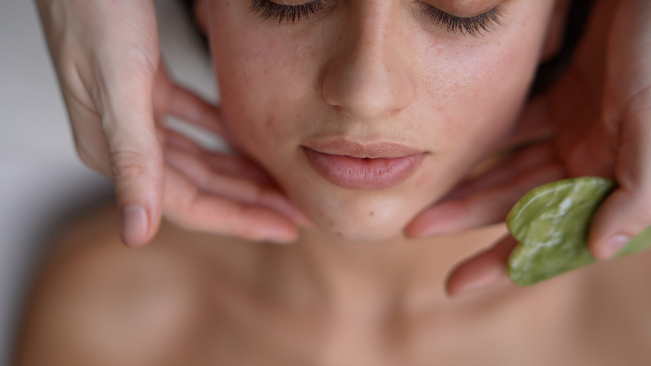 Esthetician performing a relaxing facial treatment on a client in a spa setting