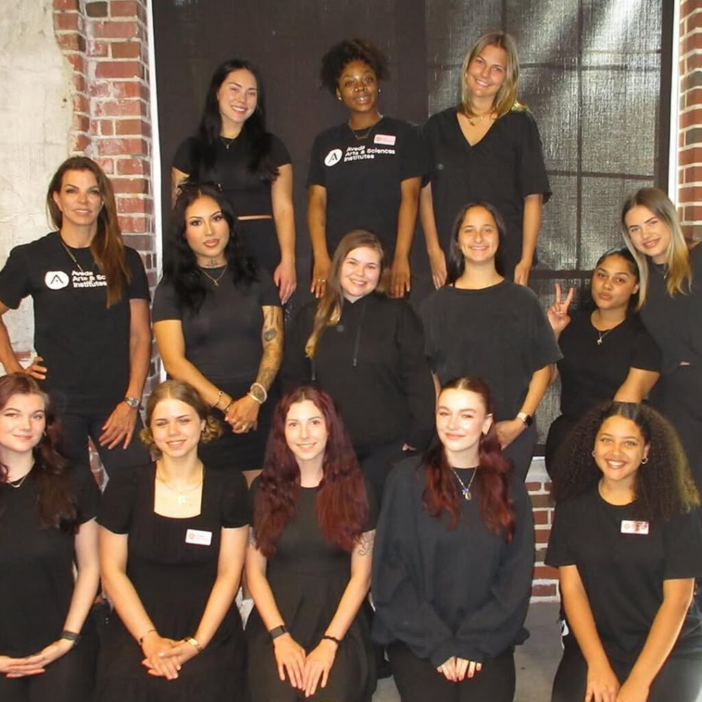 Beauty school students learning skincare treatments with instructor guidance