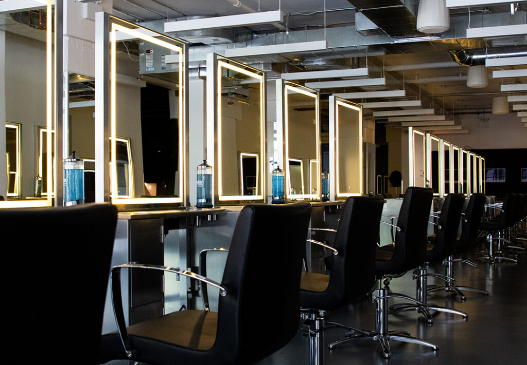 Cosmetology students use the salon clinic floor at Aveda Arts & Sciences Institute New York in DUMBO Brooklyn.