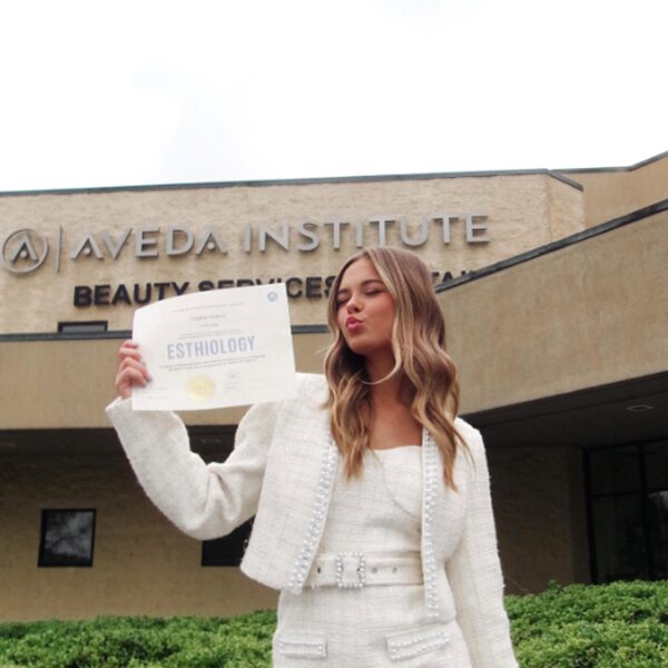 Aveda Arts Beauty School Esthetics Student Graduate Posing with Diploma