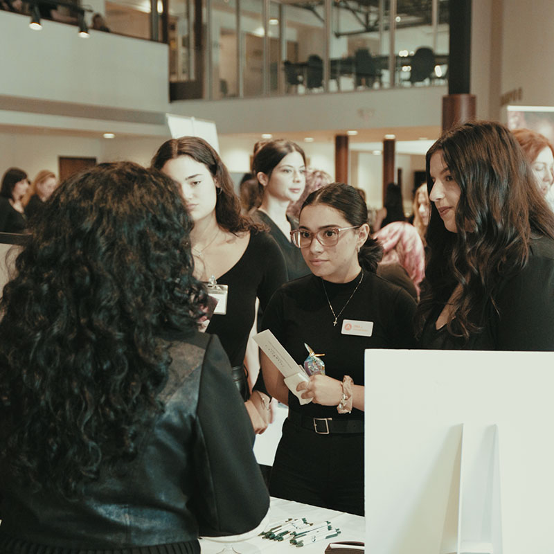 Students and salon professionals networking during Industry Days at Aveda Arts & Sciences Institutes career event.
