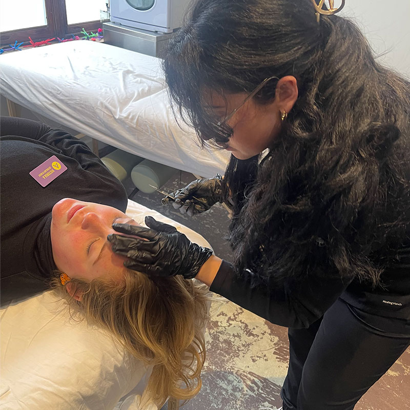Avery Meyers performing a professional skincare treatment as a licensed esthetician after graduating from Aveda Arts Hammond.