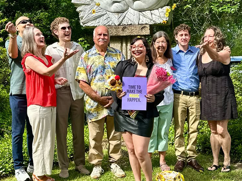 Aveda Arts cosmetology graduate Faith Bolanos smiling during graduation with her family. Mother and Daughter Beauty School Story.