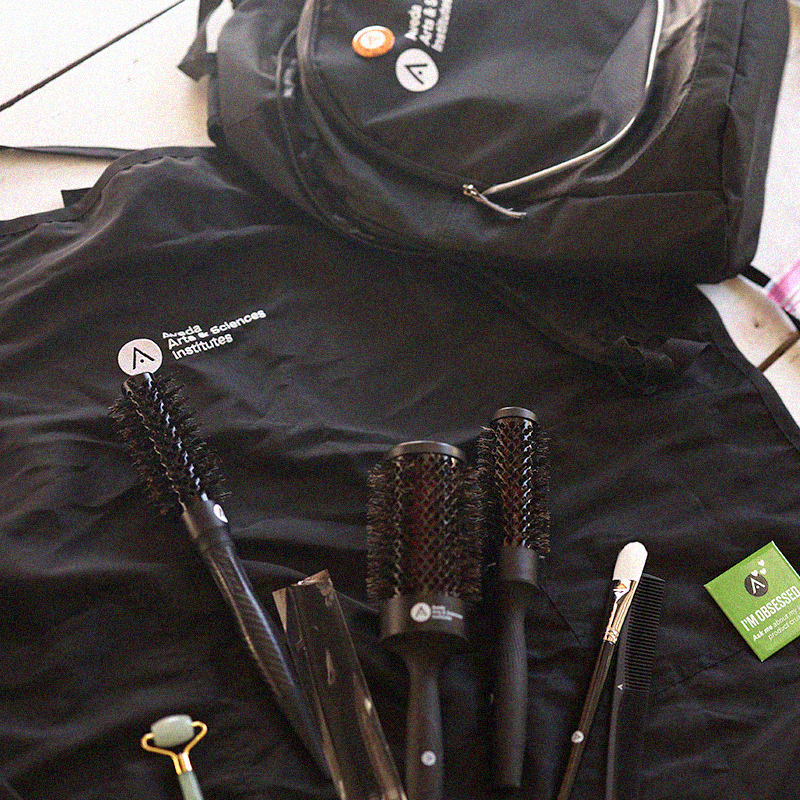 Beauty school students learning professional product knowledge during Aveda beauty education with tools.