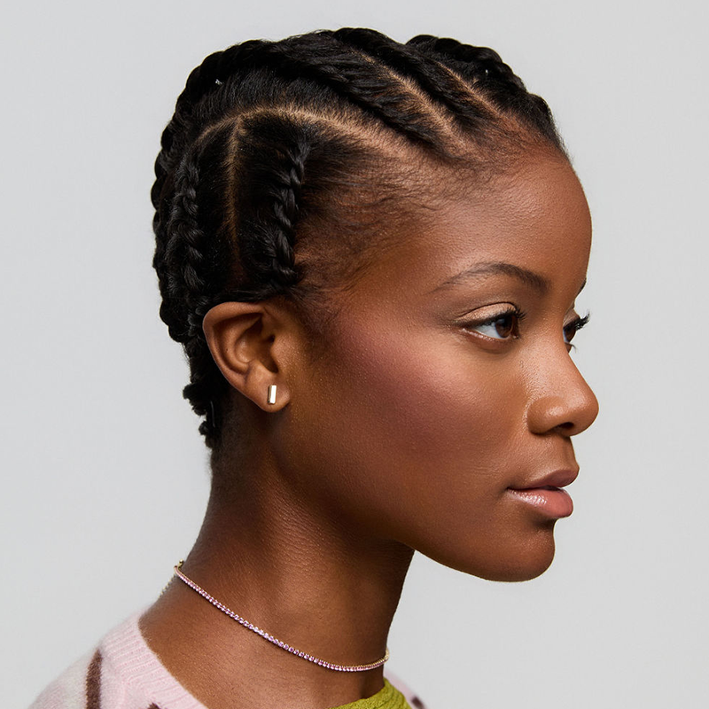 Aveda Arts student learning braiding and protective styling techniques on model